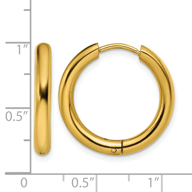 A pair of polished gold-colored chunky hoop earrings with a hinged closure, displayed next to a measurement scale showing approximately one inch in height and half inch in width.