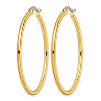 A pair of polished gold-toned hoop earrings with a smooth, rounded profile and hinged closures, displayed against a white background.