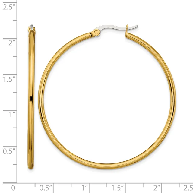 Gold-toned hoop earrings displayed next to a ruler showing they measure approximately 2 inches in diameter.