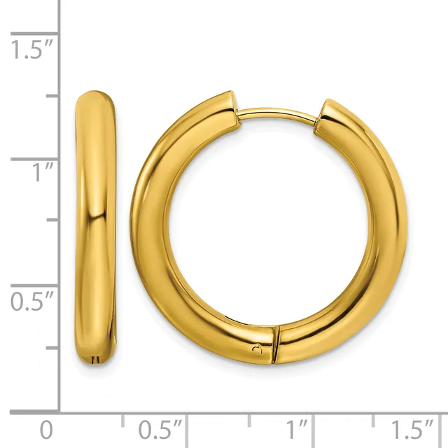 A pair of polished gold hoop earrings displayed against a measurement scale showing they are approximately one inch in diameter.