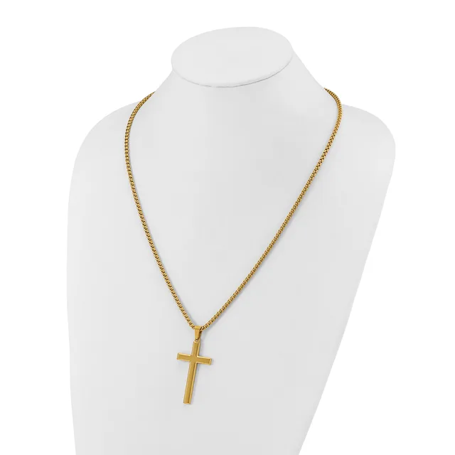 Gold-toned cross pendant hanging from a gold-toned chain necklace, displayed on a white mannequin bust.