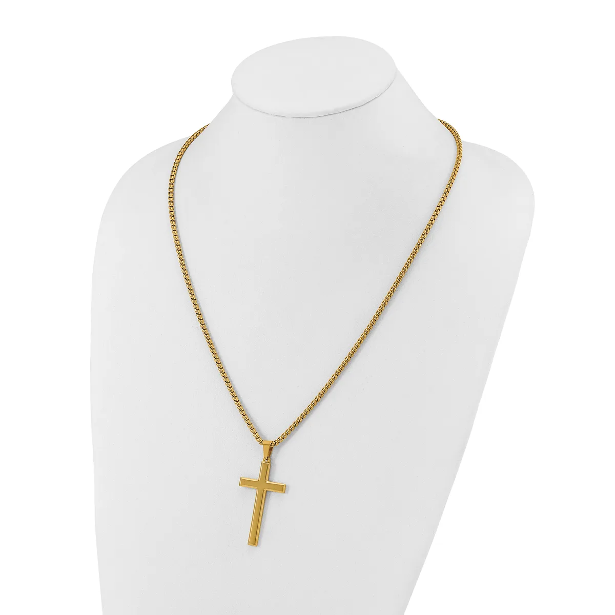 Gold-toned cross pendant hanging from a gold-toned chain necklace, displayed on a white mannequin bust.