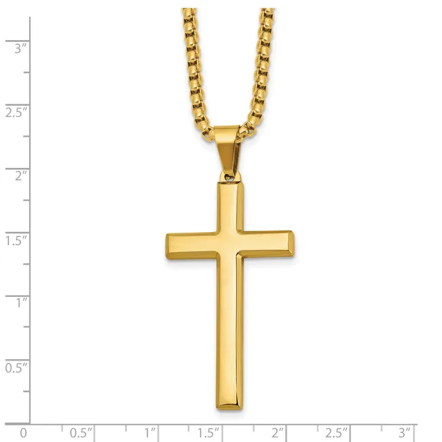 Gold-toned cross pendant on a gold box chain necklace, displayed against a ruler showing the cross is approximately 1.5 inches tall.