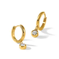 A pair of gold hoop earrings with detachable charms, each charm featuring a round diamond in a gold bezel setting.