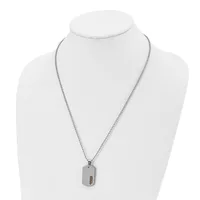 A stainless steel necklace with a fine box chain and a rectangular dog tag pendant featuring a small stamped hallmark, displayed on a white bust form.