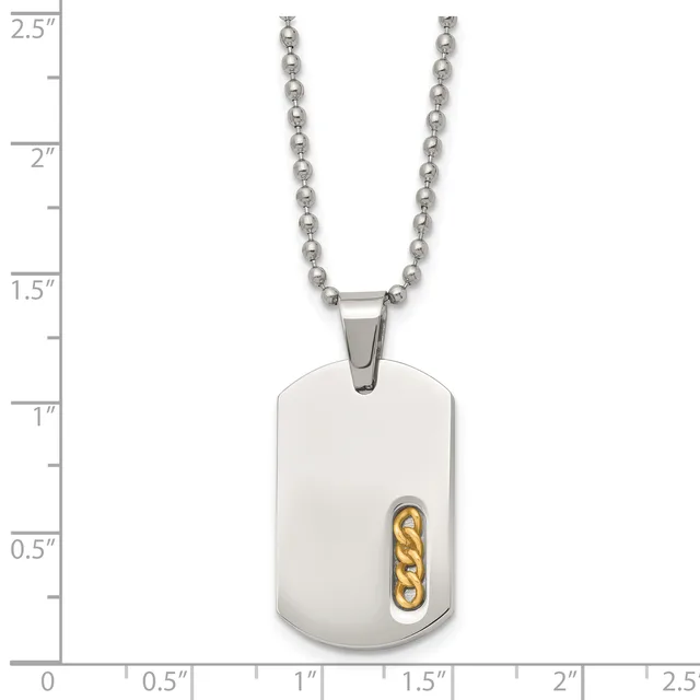 A stainless steel dog tag pendant with a gold-colored chain link accent, suspended from a beaded ball chain, shown against a measurement scale.