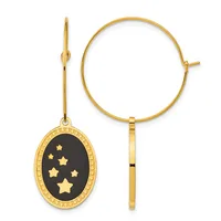 Gold-toned bangle bracelet and matching dangle earring with black oval pendant featuring gold stars and decorative border.