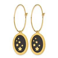 Pair of gold-toned oval hoop earrings with black enamel pendant charms decorated with gold stars.
