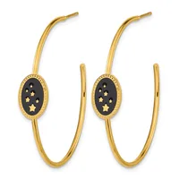 Pair of gold hoop earrings with oval black enamel plaques decorated with small gold stars.