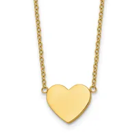 Gold heart pendant hanging from a delicate chain necklace against a white background.