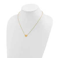 A gold-toned heart pendant necklace displayed on a white mannequin bust.