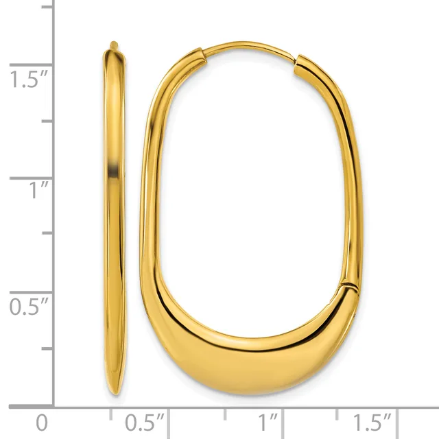 A pair of polished gold-colored oval hoop earrings with a hinged closure, displayed next to a measurement scale showing approximately 1.5 inches in length.
