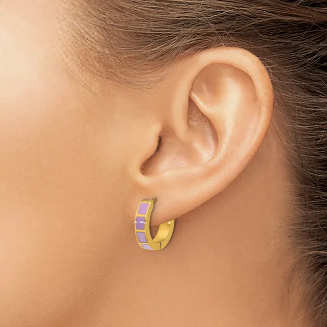 A gold hoop earring with purple enamel accents on the upper portion, shown worn on a person's earlobe.