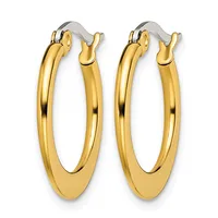 A pair of polished gold-toned oval hoop earrings with hinged closures, displayed side by side against a white background.