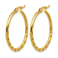 A pair of gold twisted hoop earrings with hinged posts and backs displayed against a white background.