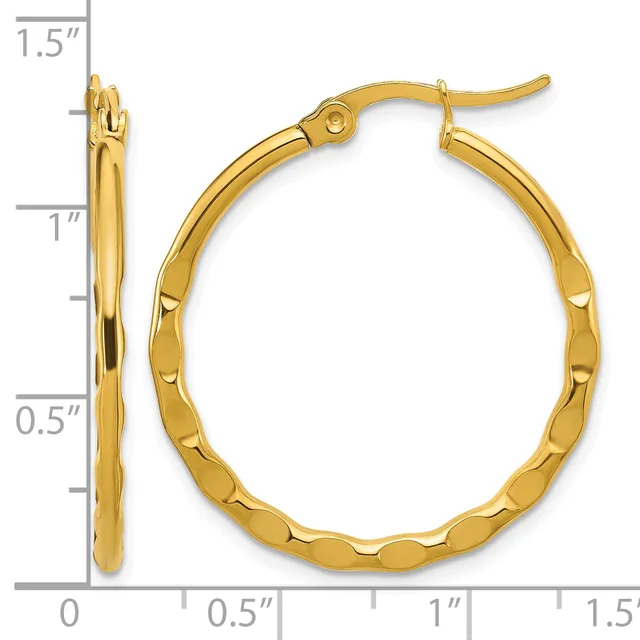 Gold-colored hoop earrings with a textured, dimpled surface and hinged posts, displayed against a measurement scale showing dimensions of approximately 1.5 inches in height.