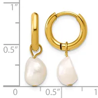 Gold-tone huggie hoop earrings with white pearl drop charms, shown next to a ruler indicating approximately one inch in length.