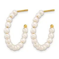Pair of gold hoop earrings with white pearl beads and small gold sphere accents, displayed against a white background.