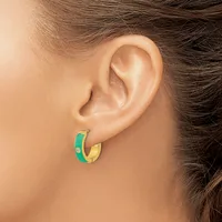 A person wearing small hoop earrings with green and gold coloring and a small rhinestone detail, shown from the side view of their ear.