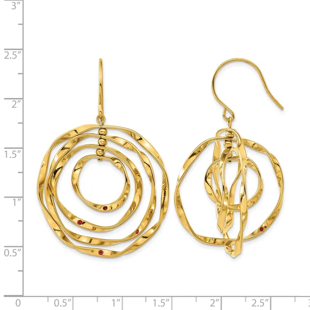 Two gold spiral dangle earrings with textured surfaces and fish hook closures, displayed against a measurement ruler showing approximately 2.5 inches in length.