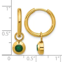 Gold-colored hoop earrings with small green gemstone charms hanging from the hoops, displayed next to a measurement scale.