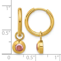 Gold hoop earrings with pink tourmaline gemstone charms, shown next to a ruler indicating approximately one inch in length.