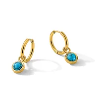 A pair of gold hoop earrings with turquoise stone pendants hanging from the hoops, displayed against a white background.