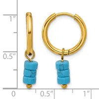 Gold-toned hoop earrings with turquoise stone beads hanging from the bottom, displayed next to a measurement scale.