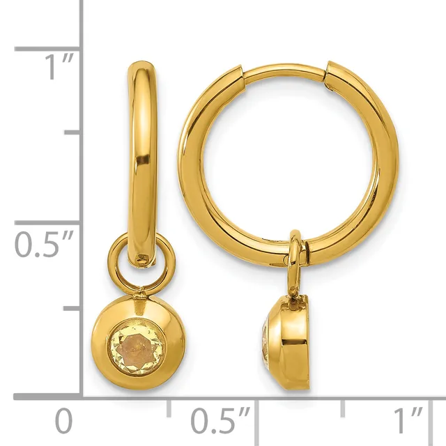 Pair of gold-colored huggie hoop earrings with detachable champagne-colored stone pendants, shown next to a measurement scale.