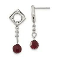 Pair of silver dangle earrings with square tops featuring circular cutouts, chain links, and faceted red gemstone drops.