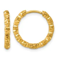 A pair of gold hoop earrings with a textured, hammered surface finish displayed against a white background.