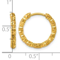 A pair of gold hoop earrings with a textured hammered finish, displayed with measurement scale showing approximately one inch in length and half inch in width.