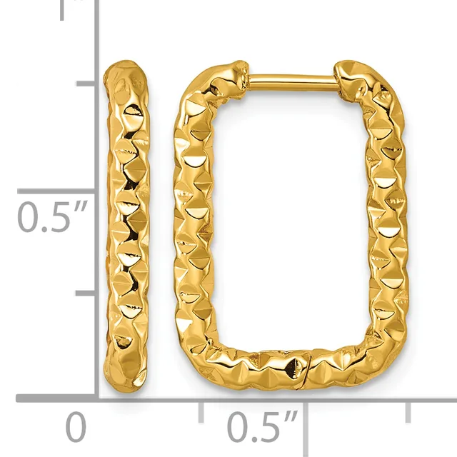 A pair of gold-colored rectangular hoop earrings with a textured, hammered surface finish, shown against a measurement scale.