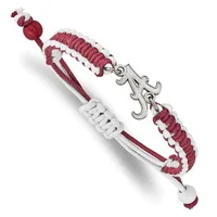 A bracelet with burgundy and white woven cord sections, silver-toned metal spacers, a decorative ornamental charm, and small beads at the ends.