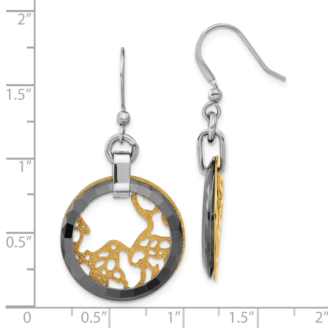 A pair of two-tone earrings with silver-colored circular frames containing gold-colored openwork designs, suspended from silver ear wires, displayed against a measurement scale.