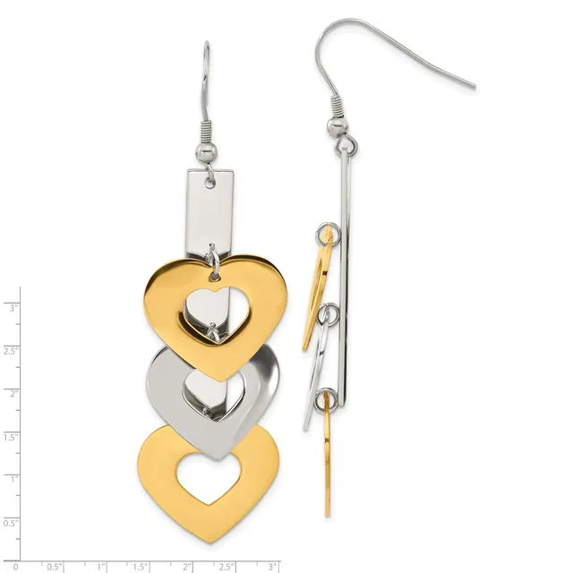 Pair of mismatched dangling heart earrings in gold and silver tones with fish hook closures, shown against a measurement scale.
