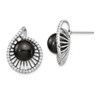 Pair of silver stud earrings featuring black onyx spheres surrounded by radiating ridged metal rays and a border of round white diamonds.