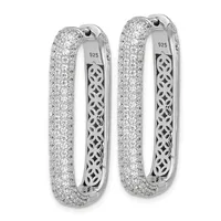 A pair of sterling silver hoop earrings with a small stamped hallmark, densely paved with round cubic zirconia stones on the outer surface and featuring an ornate lattice pattern on the inner surface.