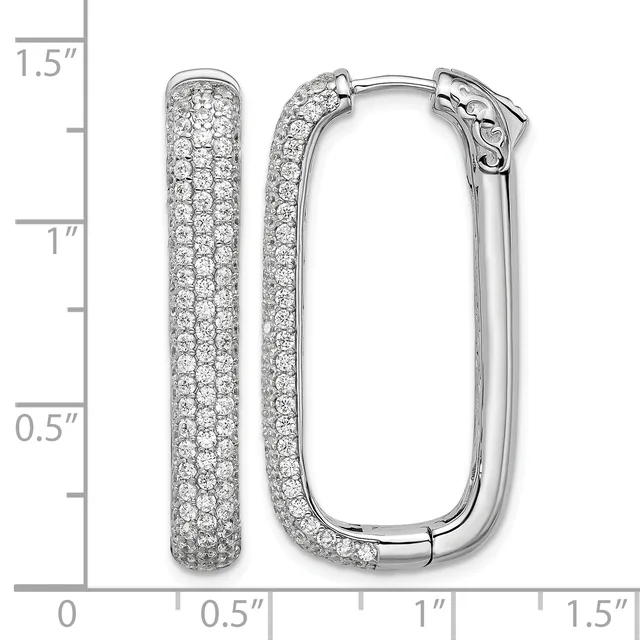 Pair of white metal hoop earrings densely paved with small round diamonds, displayed open and closed against a measurement scale showing approximately 1.25 inches in length.