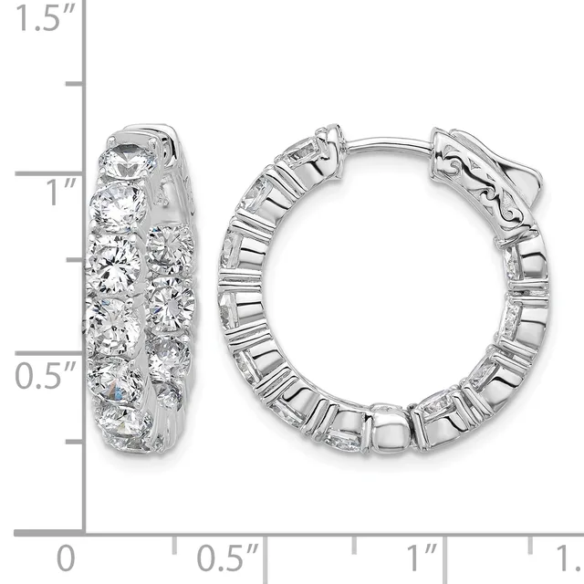 A pair of silver hoop earrings set with round diamonds, displayed next to a ruler showing their approximate 1-inch diameter size.