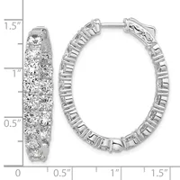Pair of silver hoop earrings densely set with round diamonds, shown from front and side views with a measurement scale indicating approximately 1.5 inches in length.