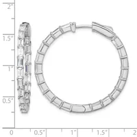 A pair of silver hoop earrings with rectangular baguette-cut cubic zirconia stones set along the outer surface, shown with a measurement scale indicating approximately 1.5 inches in diameter.