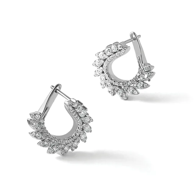 A pair of silver teardrop-shaped hoop earrings with diamond-shaped stone settings arranged around the outer edges, shown from two angles.