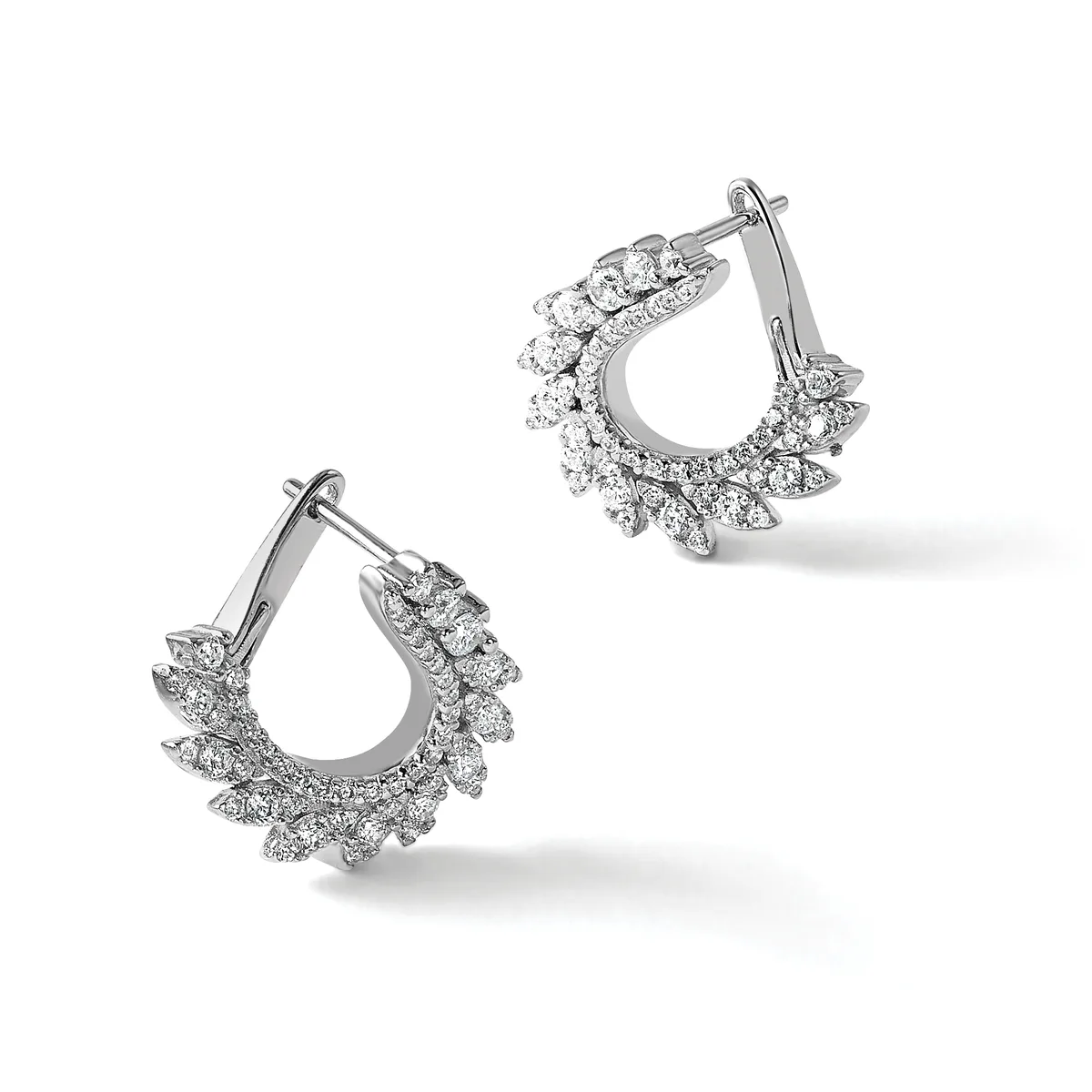 A pair of silver teardrop-shaped hoop earrings with diamond-shaped stone settings arranged around the outer edges, shown from two angles.