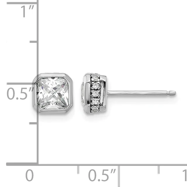 Pair of silver stud earrings with square crystal stones on the left and round diamond accents on the right, displayed against a measurement ruler.
