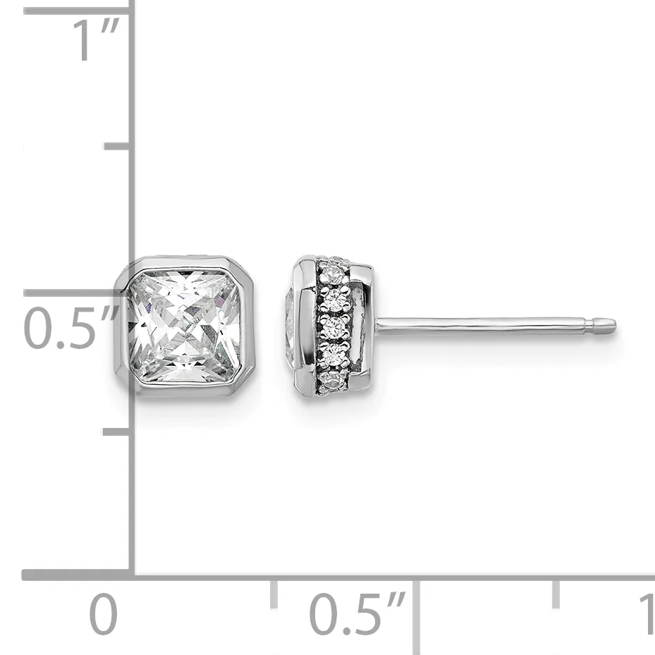 Pair of silver stud earrings with square crystal stones on the left and round diamond accents on the right, displayed against a measurement ruler.