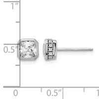 Pair of silver stud earrings with square crystal stones on the left and round diamond accents on the right, displayed against a measurement ruler.