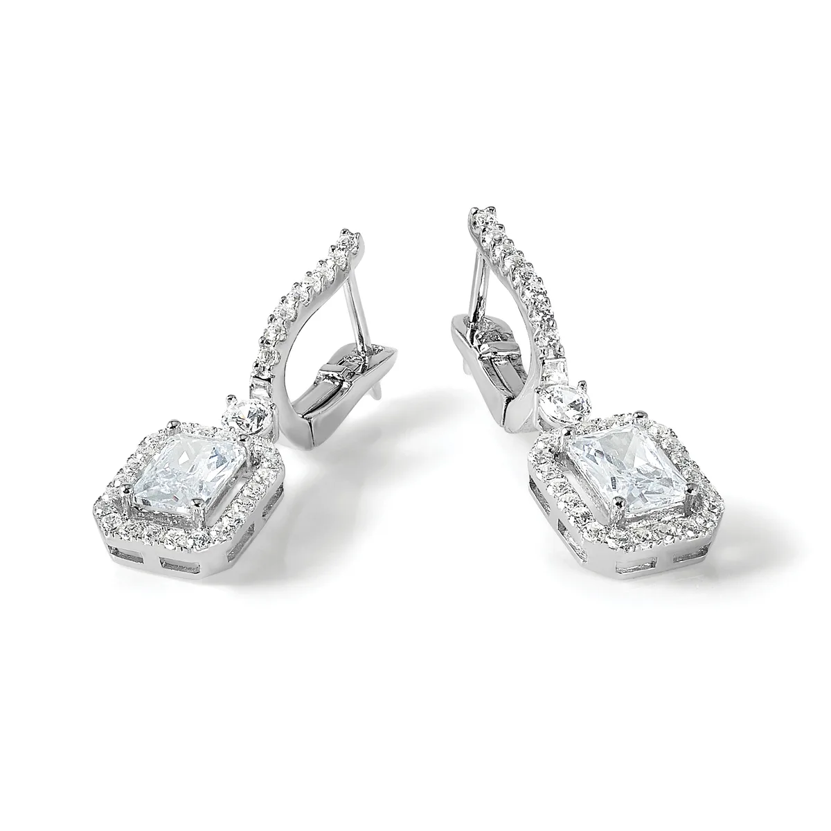 A pair of white metal drop earrings with square-cut clear gemstones surrounded by smaller diamonds, shown from a three-quarter view against a white background.