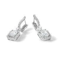 A pair of white metal drop earrings with square-cut clear gemstones surrounded by smaller diamonds, shown from a three-quarter view against a white background.