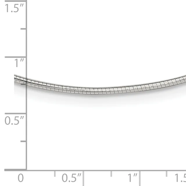 A curved metal tube or coil with a grid pattern shown against a measurement scale ranging from 0 to 1.5 inches in height and width.